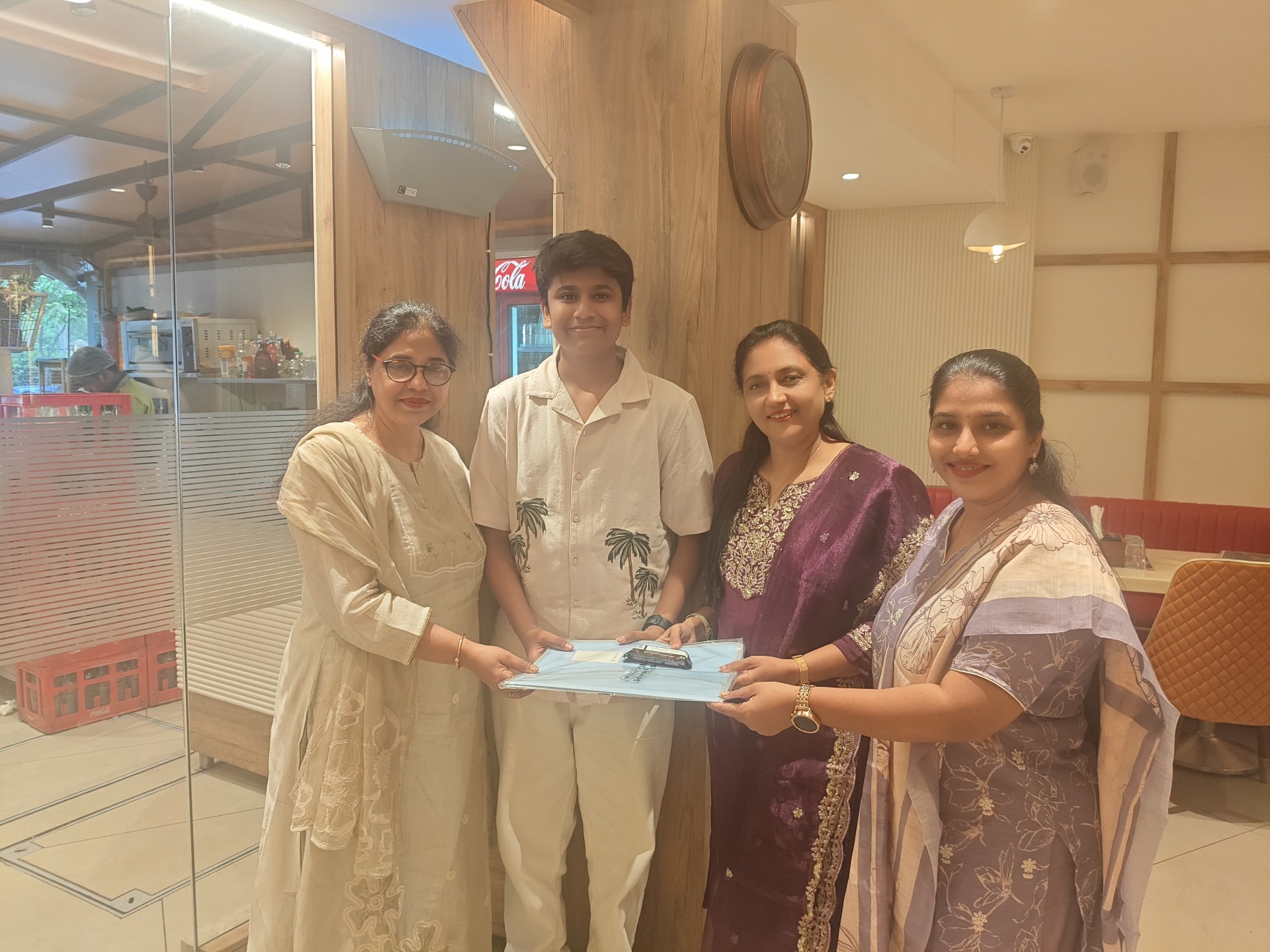 Student receiving felicitation from teachers